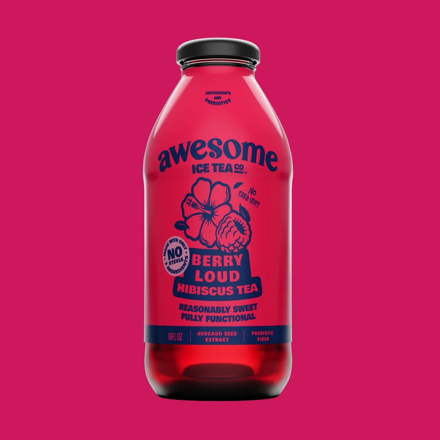 Red bottle of 'awesome ice tea co' berry hibiscus tea on a pink background